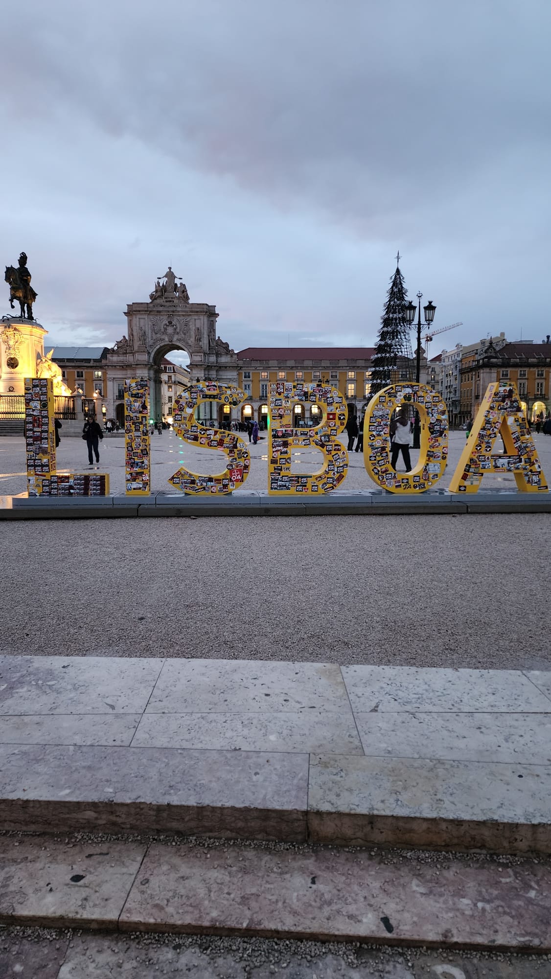 Colorful Lisbon sign displayed in a city square at dusk