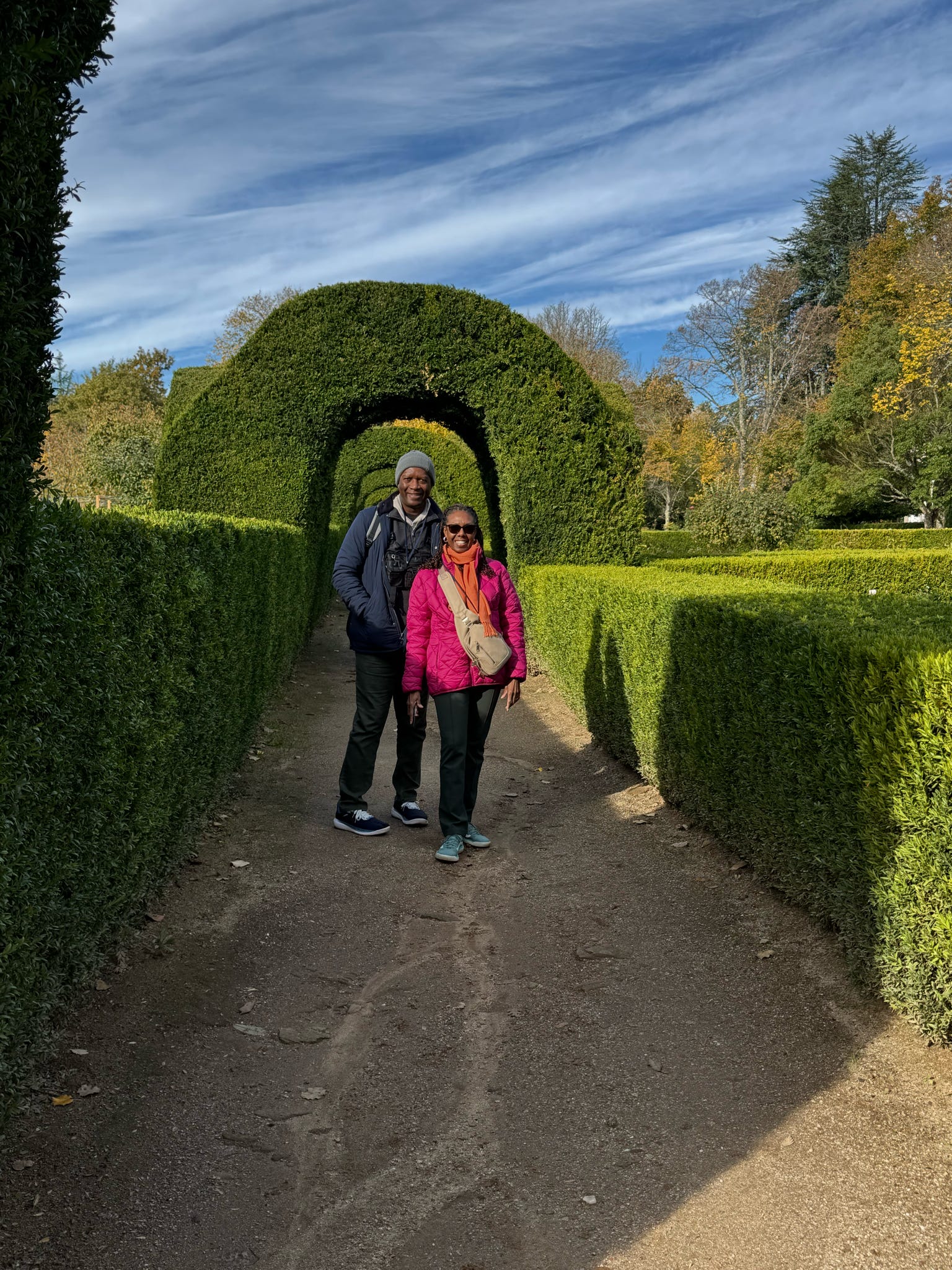 Couple walking through manicured garden pathways in Portugal