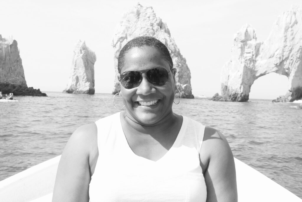 Nicole Johnson, founder, smiling outdoors during a travel experience