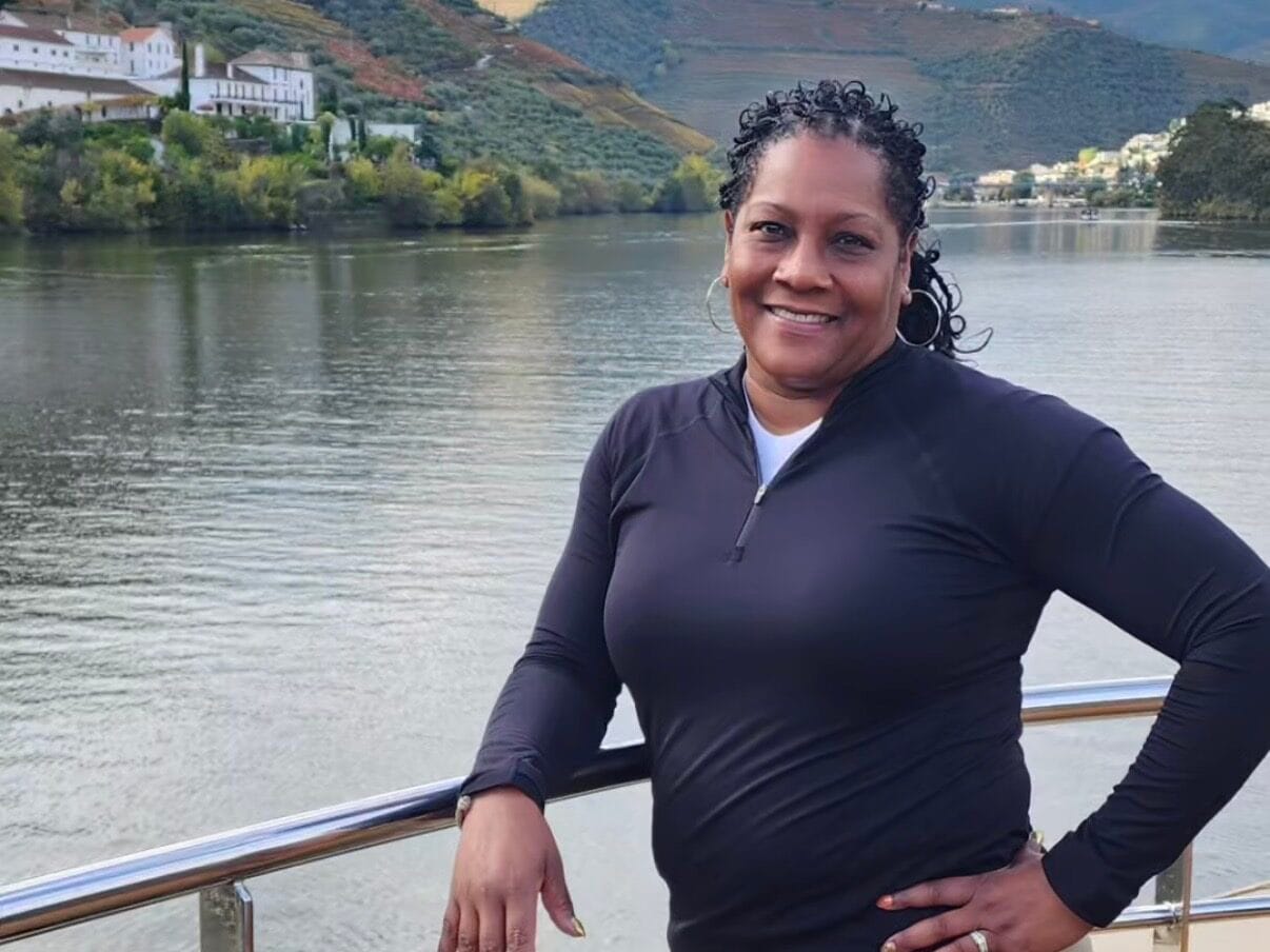 Nicole Johnson, Emerald Dreamscape Vacations, standing by the Douro River during a scenic travel experience in Portugal