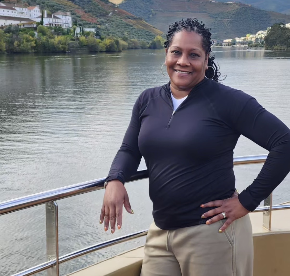 Nicole Johnson, Emerald Dreamscape Vacations, standing by the Douro River during a scenic travel experience in Portugal